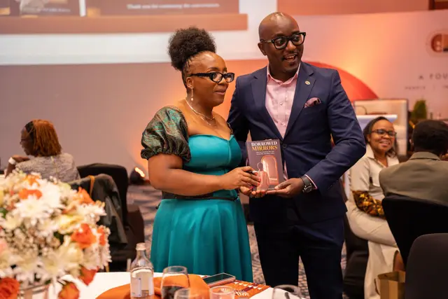A guest receiving a copy of the book